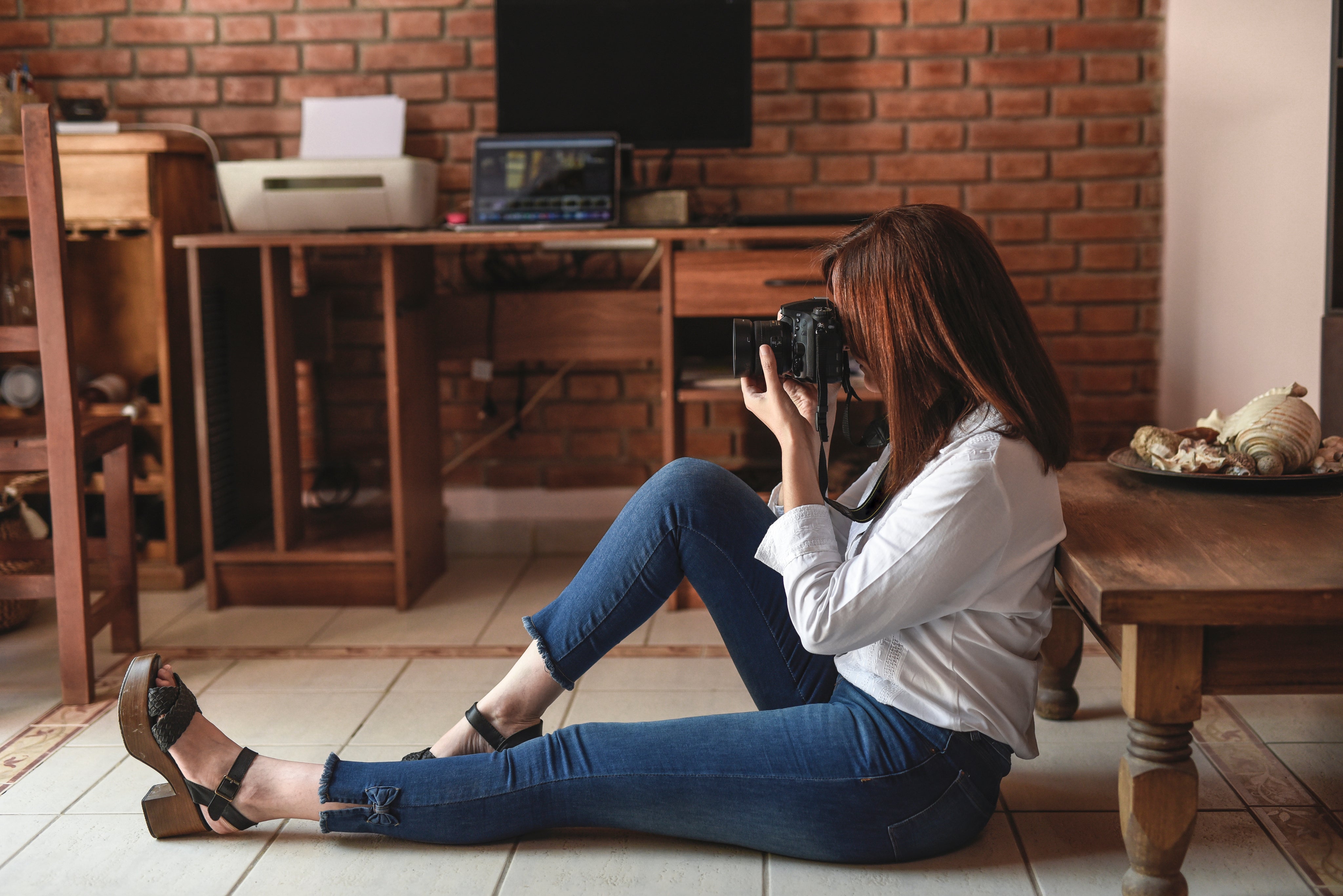 Woman taking photos in her home